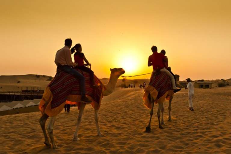 A popular choice that includes activities like desert dune bashing, camel riding, sunset photography, entertainment, sand boarding and dinner at the desert camp.